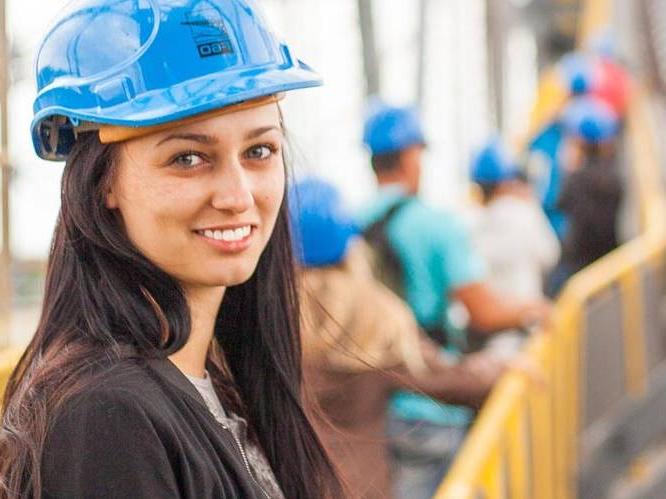 Student is wearing a blue hard hat at a construction site